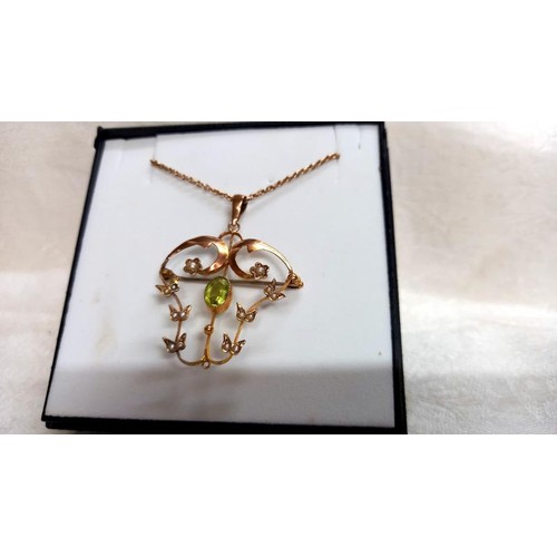 90 - An Edwardian peridot and seed pearl pendant/brooch stamped 9ct in rose gold.