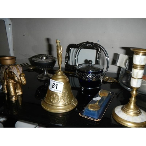 81 - A mixed lot of metalware including brass bell, elephant, candlestick etc.,