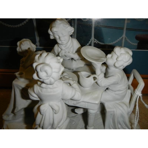 86 - A mid 20th century parian figure depicting a children's tea party.