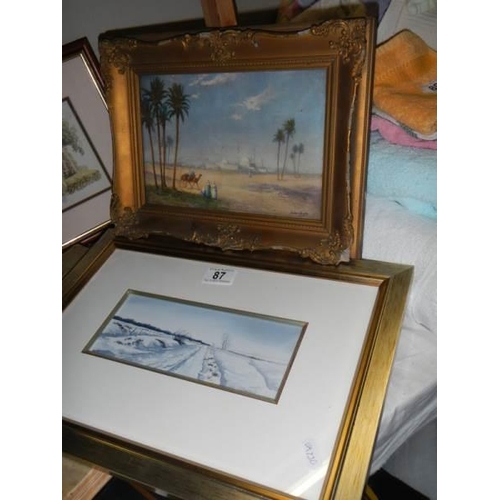 87 - A gilt framed desert scene, a study of a reclining figure and two framed and glazed pictures.