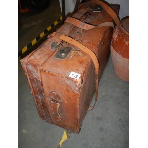 812 - A leather suitcase.