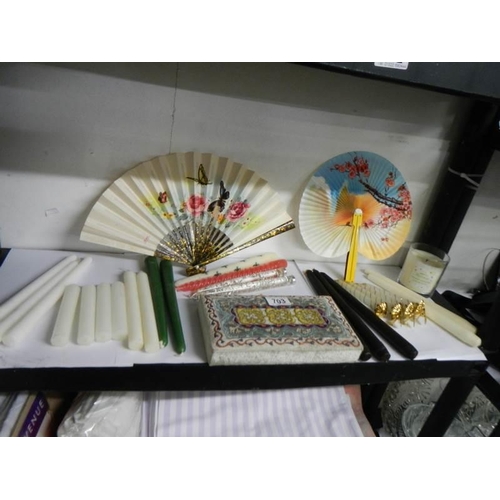 703 - An oriental fabric covered box, 2 fans and a quantity of candles.