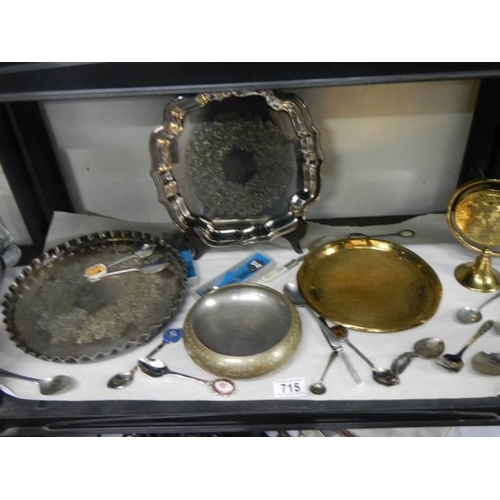 715 - A mixed lot of brass and silver plate including brass gong, spoons etc.,