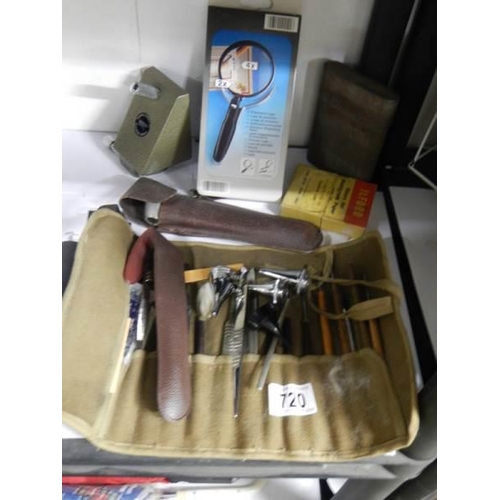 720 - A mixed lot including tool roll with contents, boxed magnifying glass etc.,