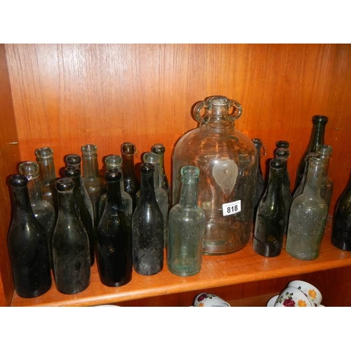 818 - A good lot of vintage bottles including a demi-john.