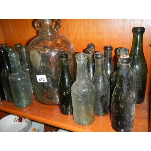 818 - A good lot of vintage bottles including a demi-john.