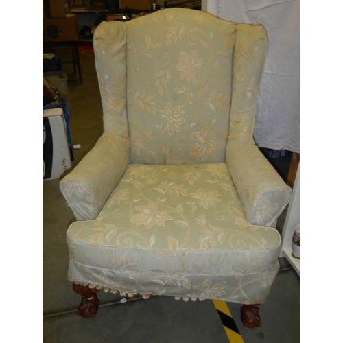 836 - A green floral wing armchair, COLLECT ONLY.