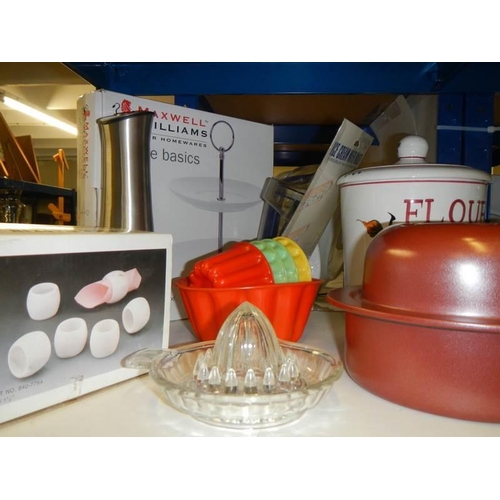 858 - A mixed lot of kitchen ware including storage jars, jelly moulds etc.,