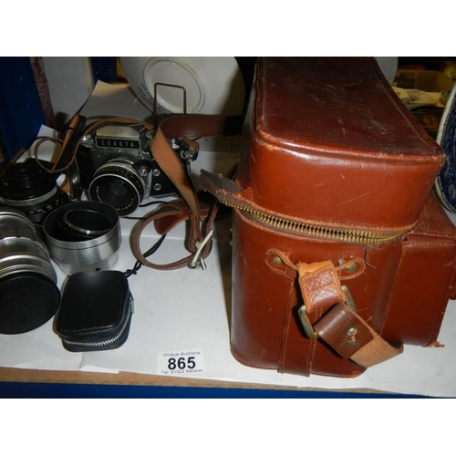 865 - A vintage Exakta camera with lenses and case.