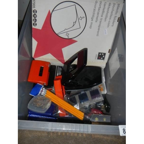 881 - A box of office supplies and filing drawers.