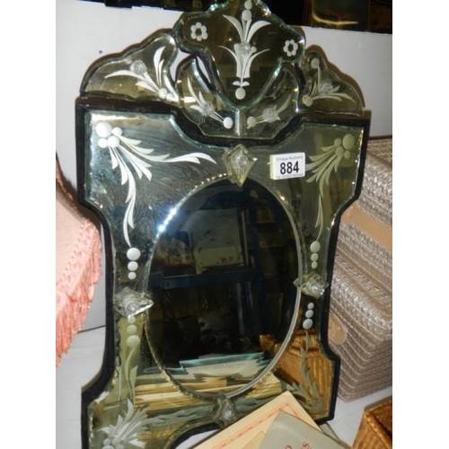 884 - A Venetian style bevelled and etched glass mirror. 31 x 51 cm. COLLECT ONLY.