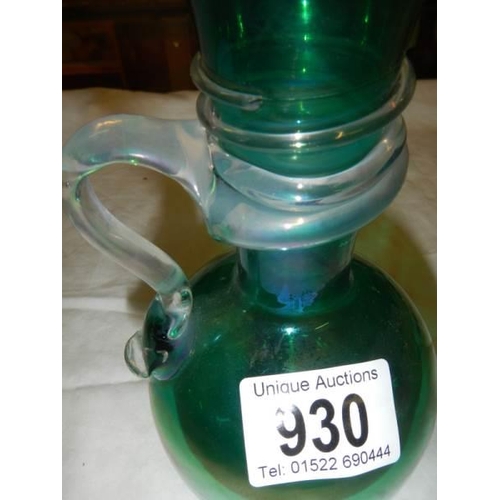 930 - An early 20th century irridescent green glass vase with wrap around handle.