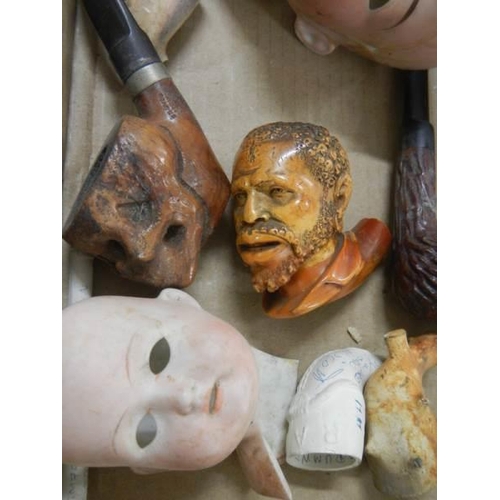 944 - A quantity of vintage pipes, bisque porcelain dolls heads etc.,