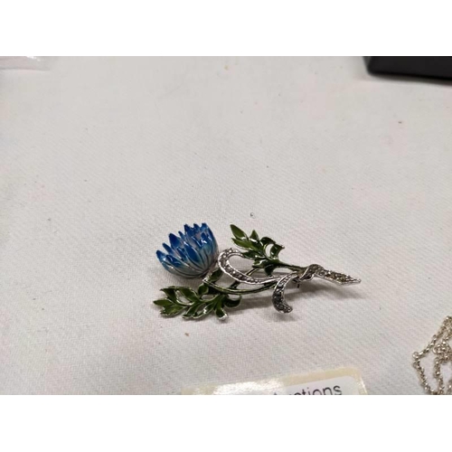 1001 - A silver pendant, silver ring and three marcasite brooches.