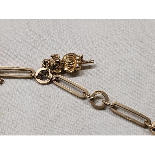 1004 - A 9ct gold charm bracelet with four gold charms and padlock, 18.5 grams.