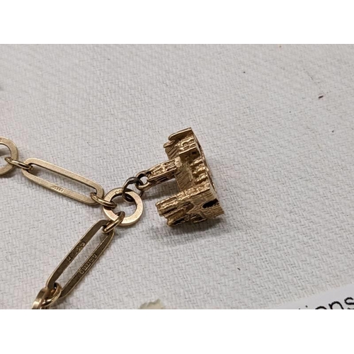 1004 - A 9ct gold charm bracelet with four gold charms and padlock, 18.5 grams.