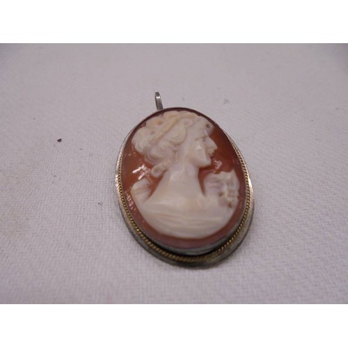 1021 - A Victorian gold brooch, cameo pendant in silver mount and a silver brooch.