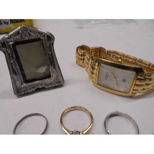 1024 - A mixed lot including small hm silver photo frame, silver rickshaw, gold pendant, 3 dress rings, loc... 