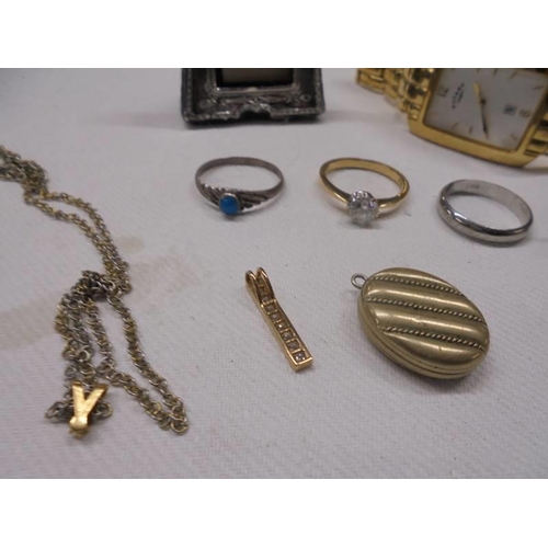 1024 - A mixed lot including small hm silver photo frame, silver rickshaw, gold pendant, 3 dress rings, loc... 