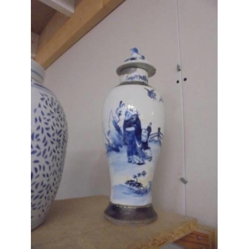 1031 - A pair of Chinese blue and white lidded vases (a/f some signs of repair) and a later blue and white ... 