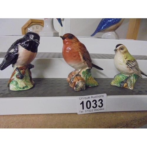 1033 - Three Beswick birds, a Royal Copenhagen bird and two others.