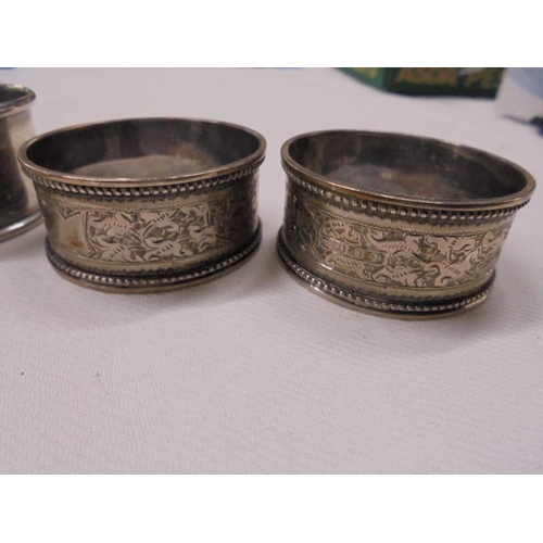 1038 - Five assorted silver napkin rings, 76 grams.