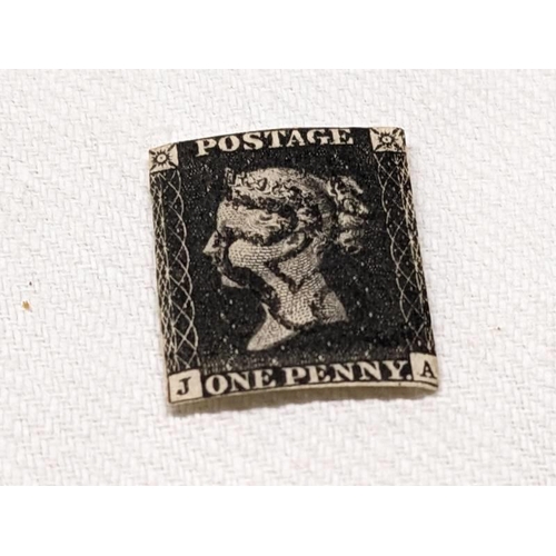 1042 - A Victorian penny black postage stamp.