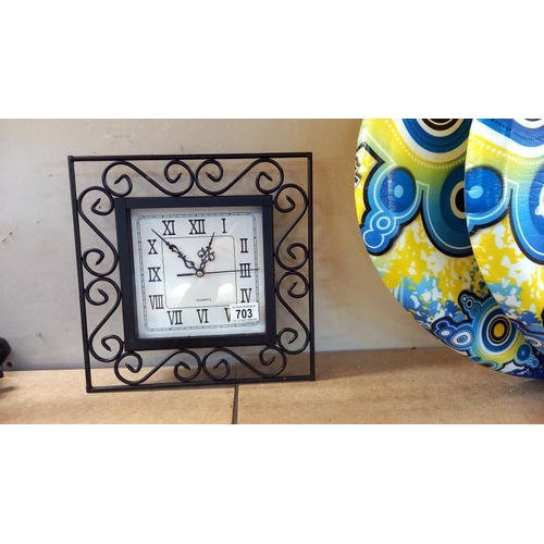 703 - A decorative wall clock and candle sconce