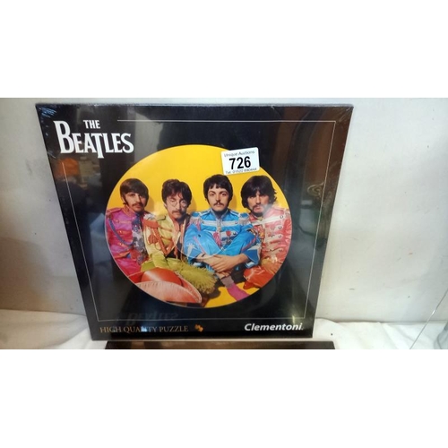 726 - 3 sealed 'The Beatles' LP sized round jigsaws