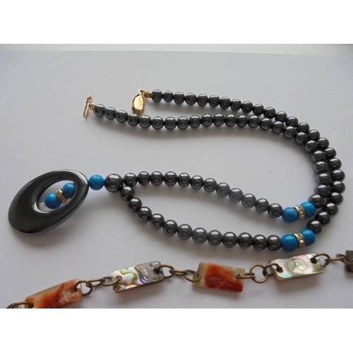 1056 - A vintage abalone shell necklace together with a hematite necklace with turquoise coloured stone ins... 