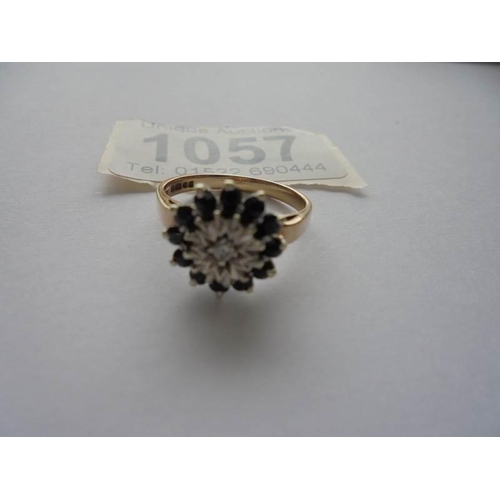 1057 - A diamond and sapphire ring in 9ct gold hall marked Birmingham 1976 size M half.