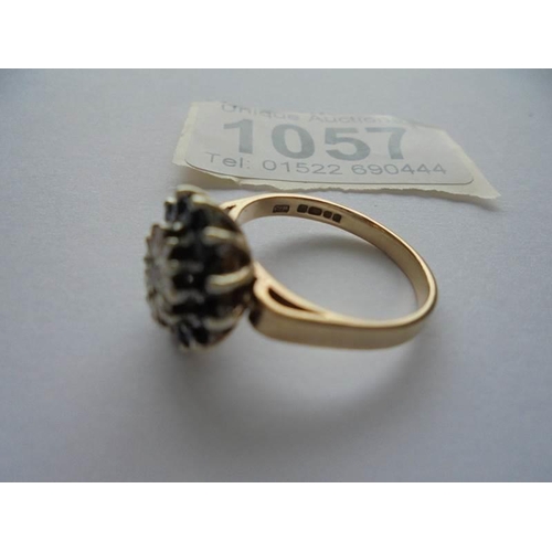 1057 - A diamond and sapphire ring in 9ct gold hall marked Birmingham 1976 size M half.