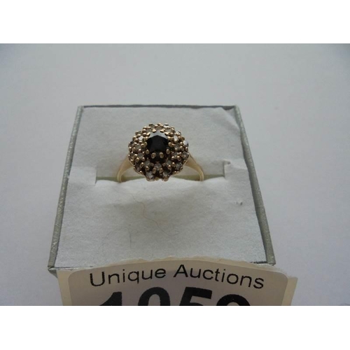 1059 - A sapphire and diamond ring in 9ct gold, dated London 1983, size N.