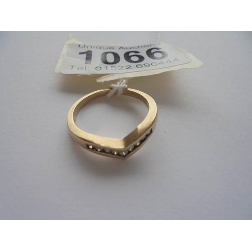 1066 - A 9ct gold ring fashioned as a wishbone, set diamonds, size N, 2.6 grams, .15 carat.