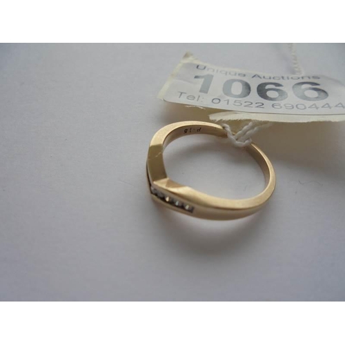 1066 - A 9ct gold ring fashioned as a wishbone, set diamonds, size N, 2.6 grams, .15 carat.