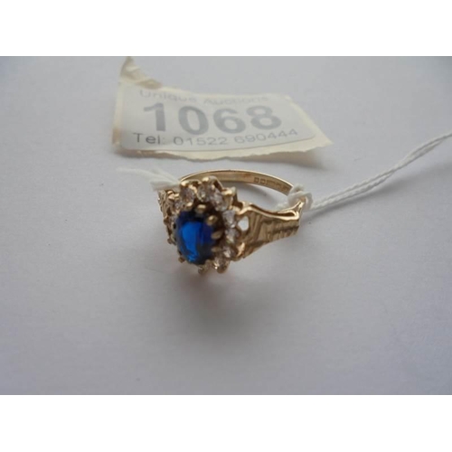 1068 - A 9ct gold white and blue stone ring with textured shoulders, Birmingham 1978, size M.