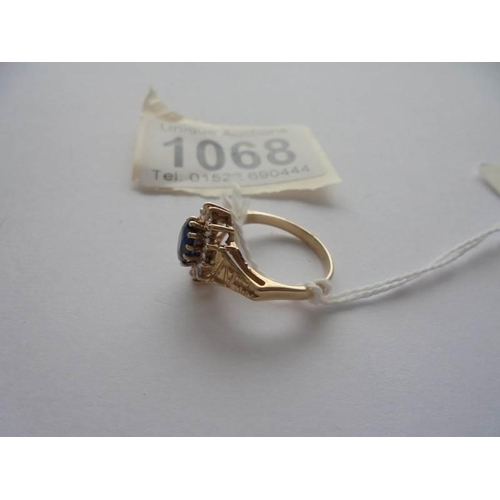 1068 - A 9ct gold white and blue stone ring with textured shoulders, Birmingham 1978, size M.