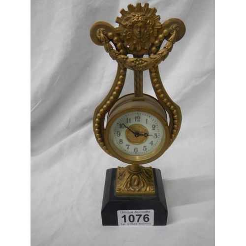 1076 - A brass lyre shaped mantel clock on slate base, a/f.