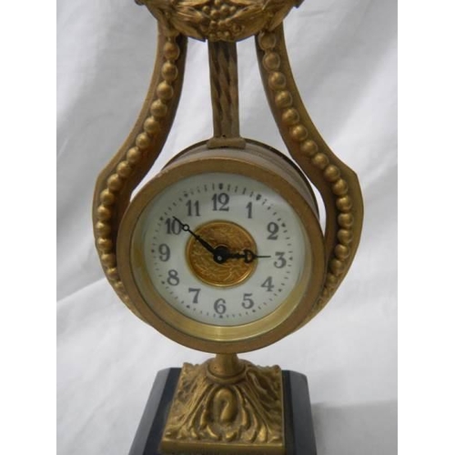 1076 - A brass lyre shaped mantel clock on slate base, a/f.