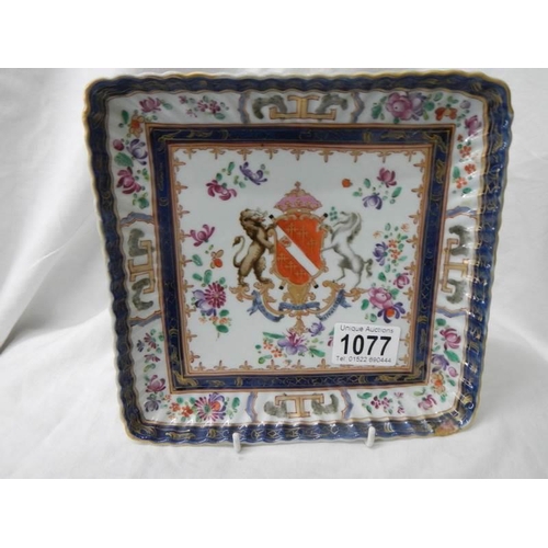 1077 - A 20th century hand painted armourial plate. Damaged in one corner.