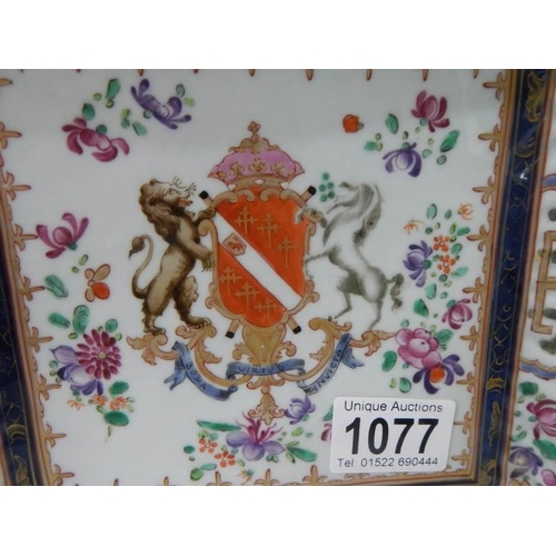 1077 - A 20th century hand painted armourial plate. Damaged in one corner.