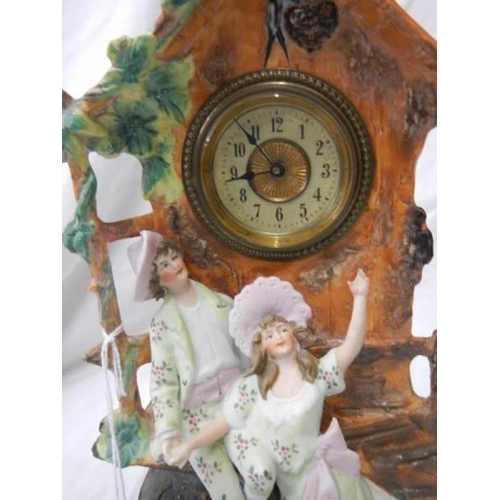 1080 - An early 20th century bisque porcelain mantel clock in working order.