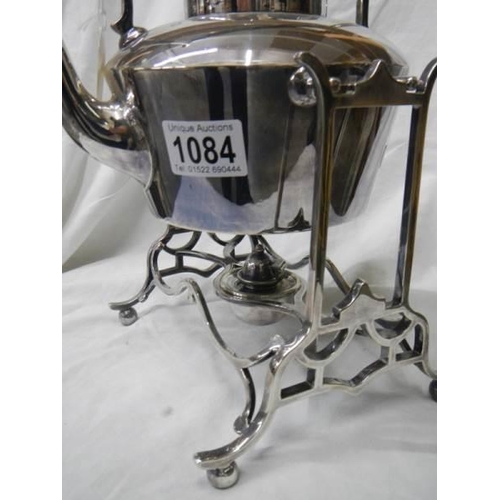 1084 - An early 20th century silver plate kettle on stand.