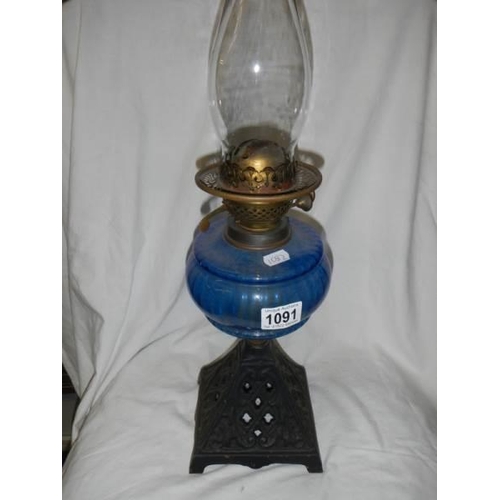 1091 - An early 20th century oil lamp with blue glass font.