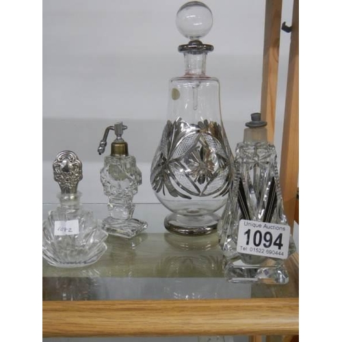 1094 - A large old perfume bottle and three smaller examples.