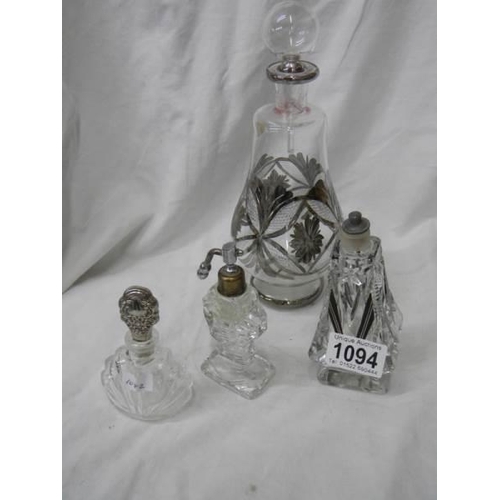 1094 - A large old perfume bottle and three smaller examples.