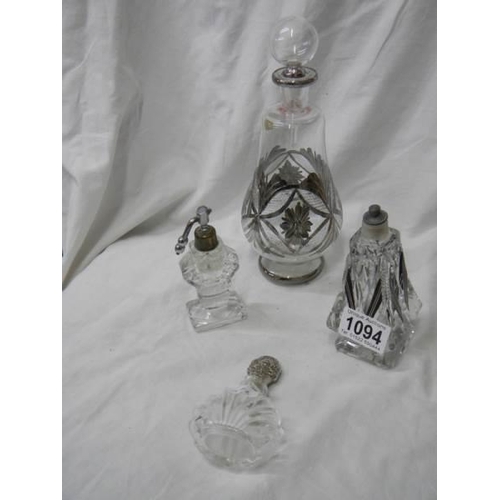 1094 - A large old perfume bottle and three smaller examples.