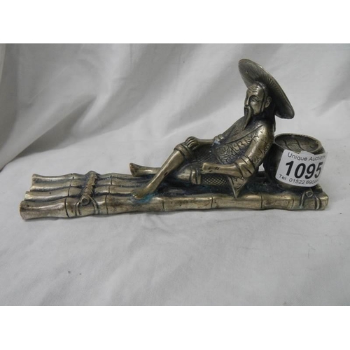 1095 - A metal figure of an oriental fisher man.