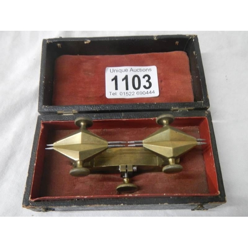 1103 - An unusual cased brass measuring item.