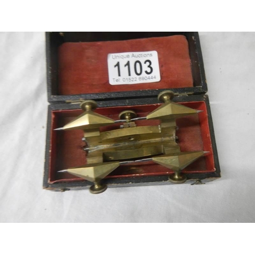 1103 - An unusual cased brass measuring item.